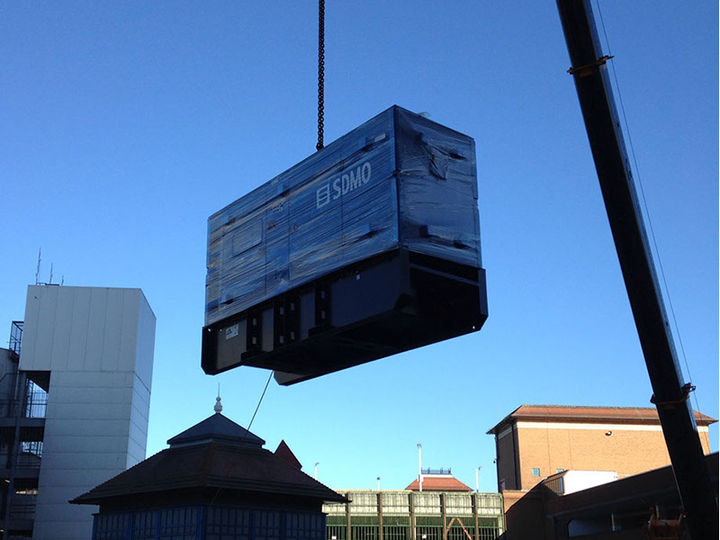 A generator being crained onto a building top and installed for a local council by Enhanced Power Services Ltd