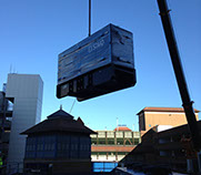 A generator being crained onto a building top and installed for a local council by Enhanced Power Services Ltd