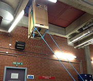 UPS (uninterruptible power supply) being hoisted up and through a small opening during installation by Enhanced Power Services Ltd.