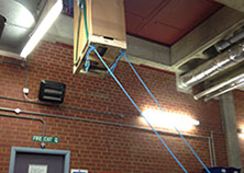 UPS (uninterruptible power supply) being hoisted up and through a small opening during installation by Enhanced Power Services Ltd.